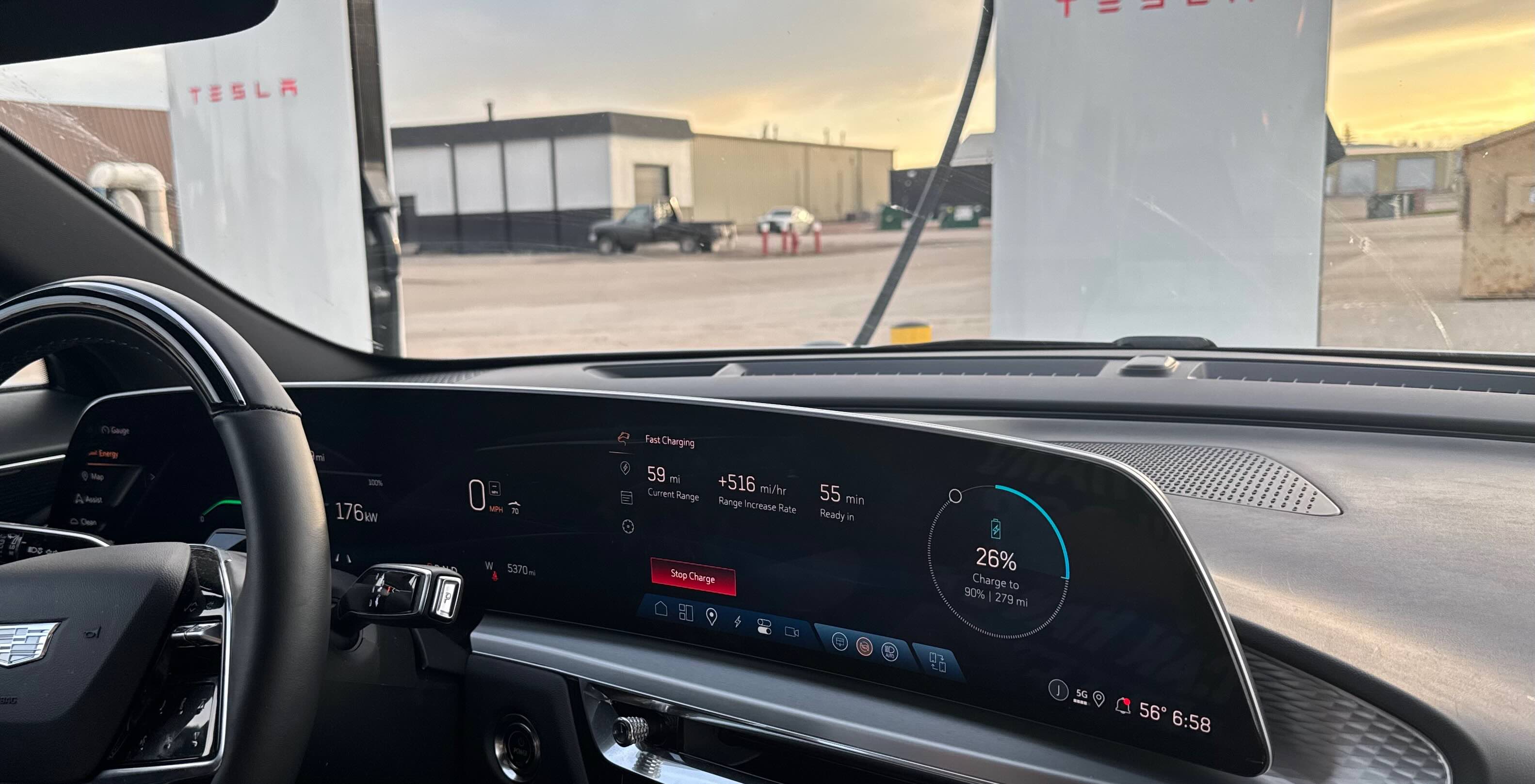 Lyriq dash display fast charging at a Tesla Supercharger, showing 26% battery and 176 kW